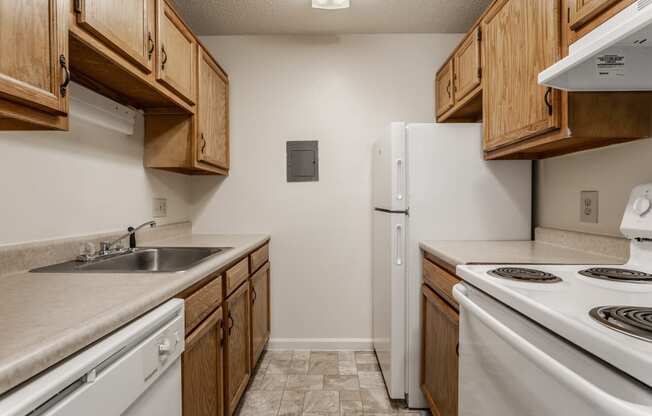 a kitchen with wooden cabinets and white appliances