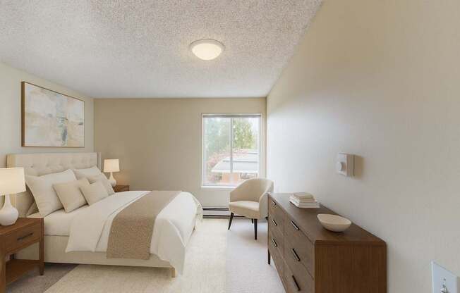 A bright bedroom here at Watercrest with soft carpet, neutral walls, and a large window, featuring a comfortable bed with light bedding, matching bedside tables with lamps, and a wooden dresser, creating a warm and relaxing atmosphere.