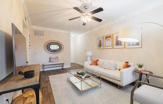 A living room with a white couch and a coffee table.