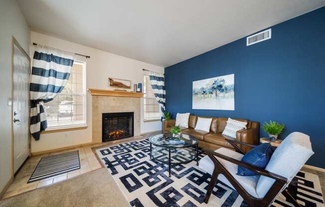 the living room with blue walls and a fireplace