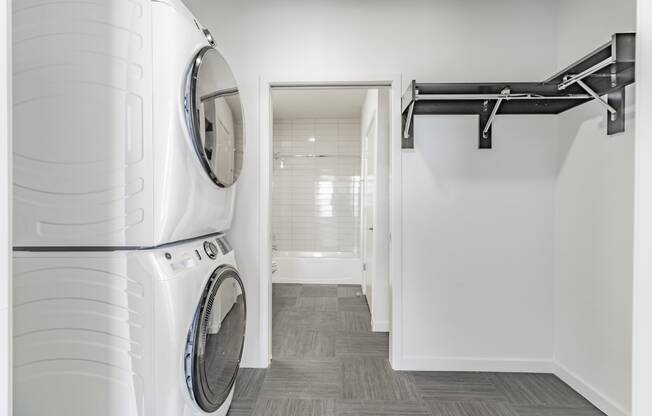 Stacked in-unit washer and dryers in each apartment home at Pinnacle Heights Apartments in Rogers, Arkansas.