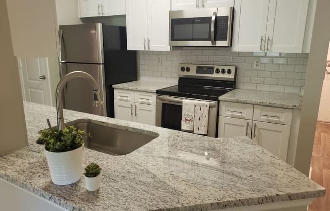 Renovated kitchen with granite at The Orleans of Decatur, Decatur