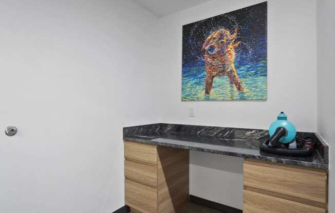 a painting of a dog on the wall of a bathroom at The Flats at Riverwoods, Utah, 84604