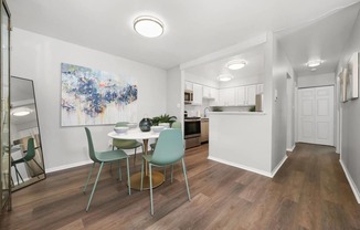 a dining room and kitchen with a table and chairs