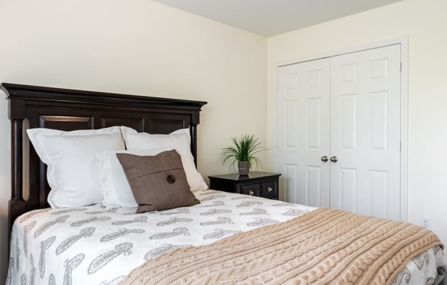 a bedroom with a large bed and a white door