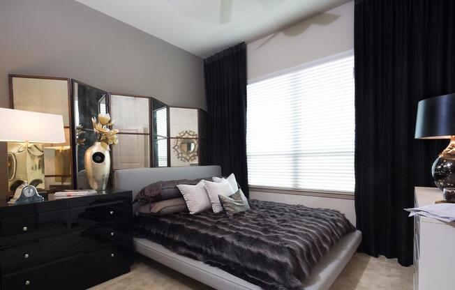 bedroom with large window and ceiling fan