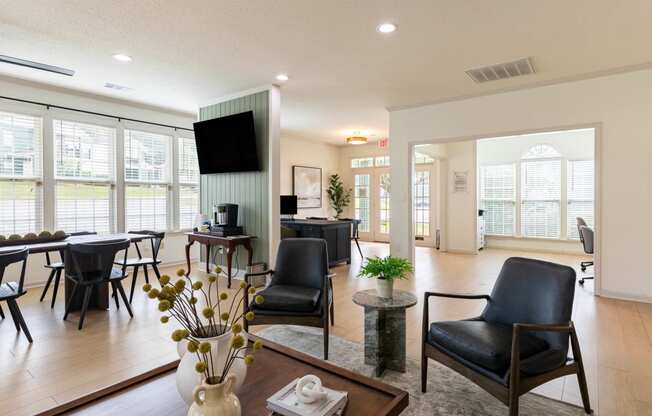 the living room and dining area of a home with a large window