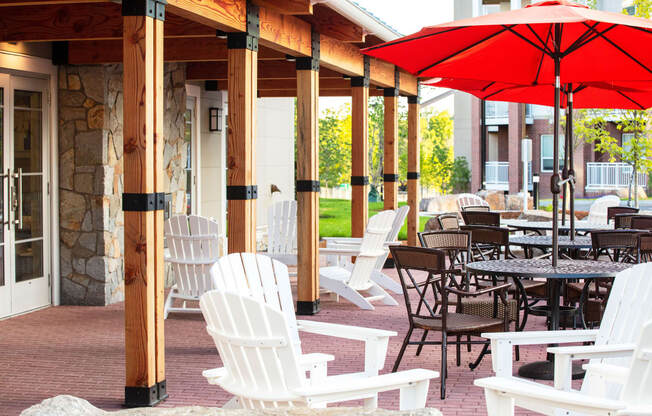 a covered patio with tables and chairs and umbrellas