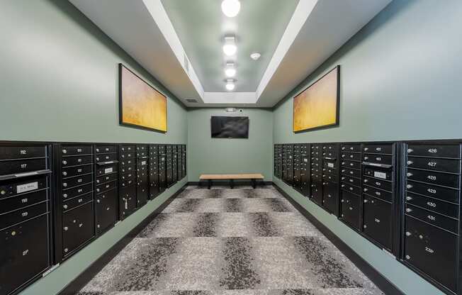 A hallway with a checkered floor and a bench in the middle.