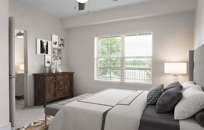 A bedroom with a bed, dresser, and window with blinds.