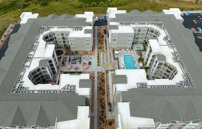 A large white building with a pool in the middle.