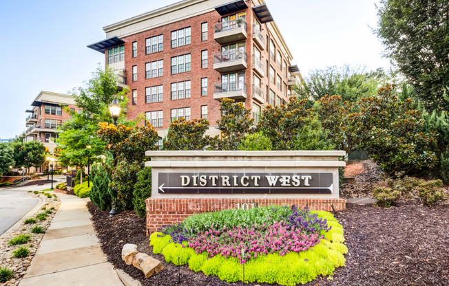 a sign for district west in front of a building