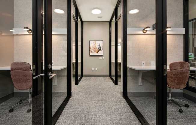 A hallway with glass doors and carpeted floors.