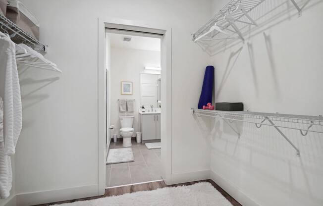 a white bathroom with a white rug and a closet at Sinclaire on Seminary, Alexandria Virginia