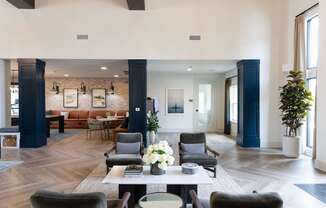 A large, modern living room with a long table and chairs.