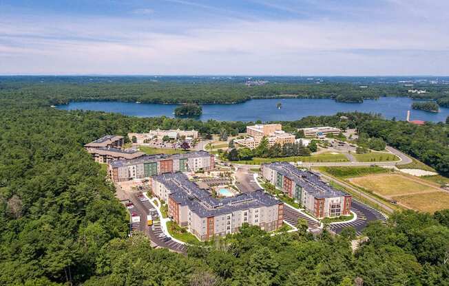 an aerial view of an apartment complex near a lake