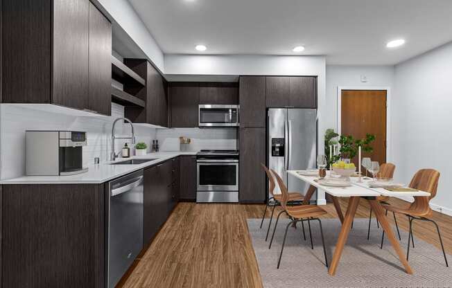 a kitchen and dining room with a table and chairs