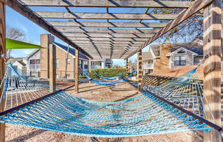 A blue rope bridge in a residential area.