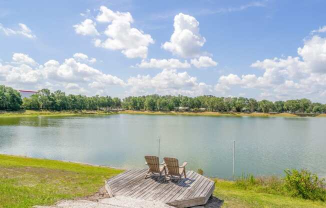 two chairs on a dock overlooking a lake