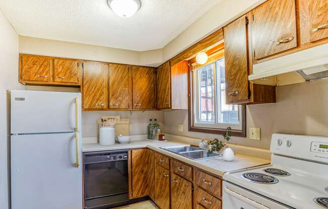 Kitchen wood cabinets white appliances large window