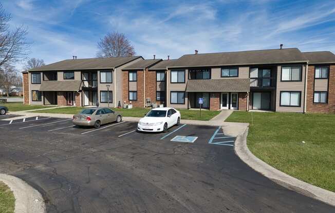 an apartment building with cars parked in front of it