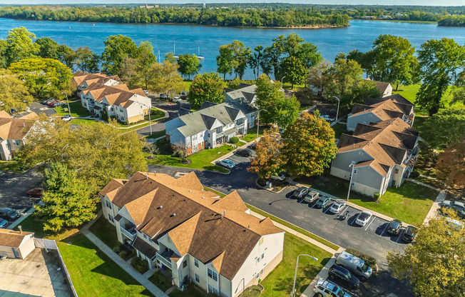 a neighborhood of houses with a river in the background