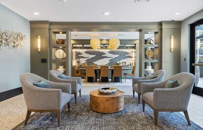 A living room with grey chairs and a wooden coffee table.