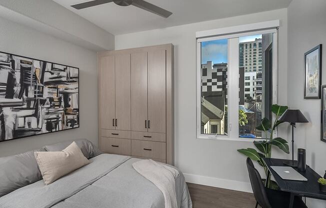 a bedroom with a bed and a desk with a chair