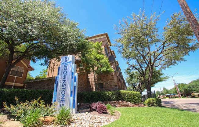 This is a photo of the monument sign/grounds at The Brownstones Townhome Apartments in Dallas, TX.