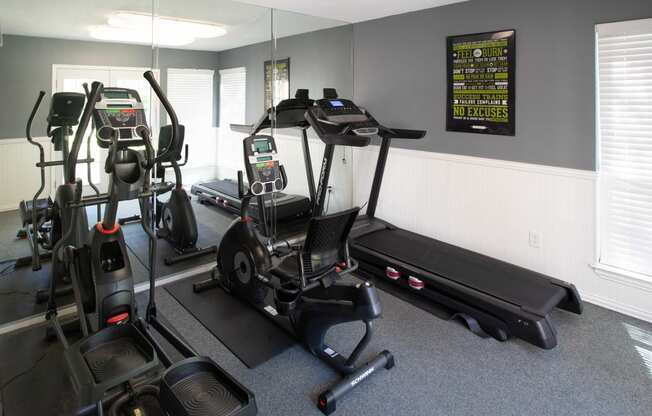 View of cardio center with treadmill, stationary bike, and elliptical