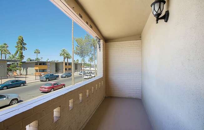 a balcony with a view of a parking lot