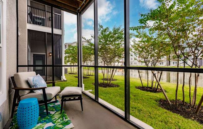 a screened in balcony with a chair at Vantage Luxury Apartments in Cape Coral, FL