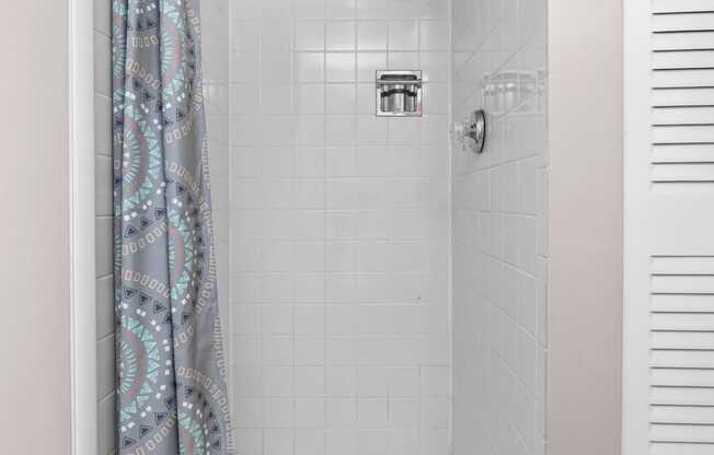 a bathroom with a shower and a curtain