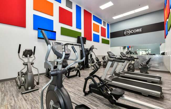 a room filled with lots of cardio exercise equipment