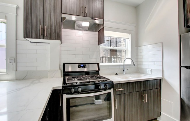 a clean kitchen with a stove and a sink