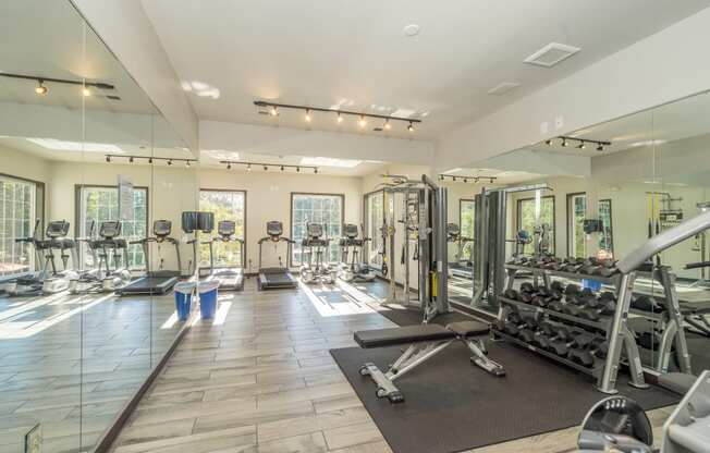 a gym with cardio equipment and mirrors on the wall at Radbourne Lake Apartments, Charlotte, NC ? 