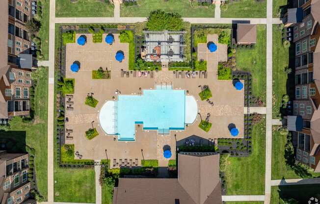 an overhead view of a building with a pool in the middle