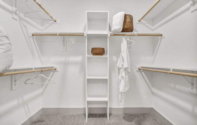 A white closet with a shelf and a basket on top.