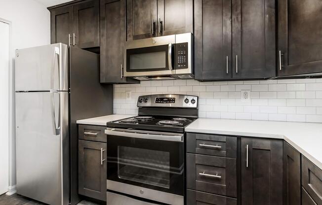 a kitchen with stainless steel appliances and wooden cabinets