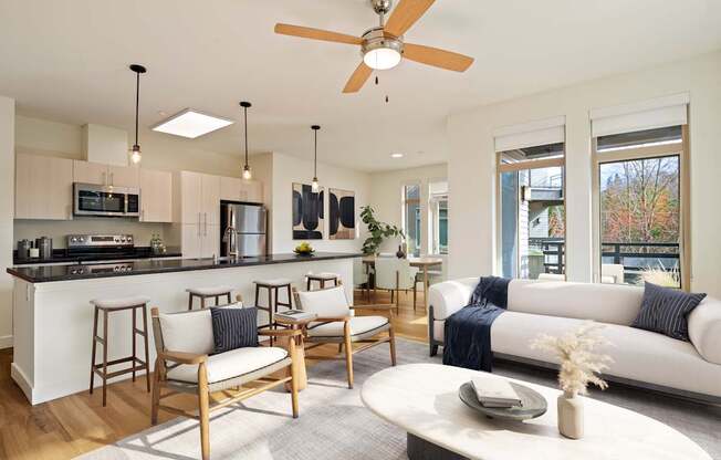 A modern kitchen with a bar area and a living room with a couch.