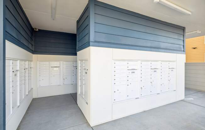 a locker room with lockers and a row of mailboxes