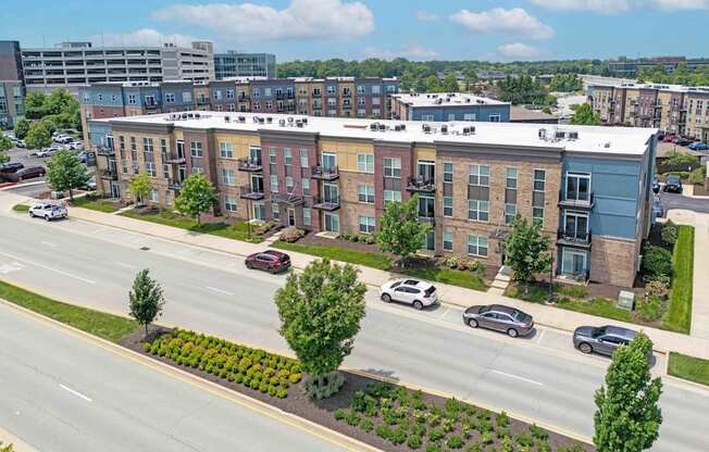 A street view of a residential area with cars parked on the side of the road.