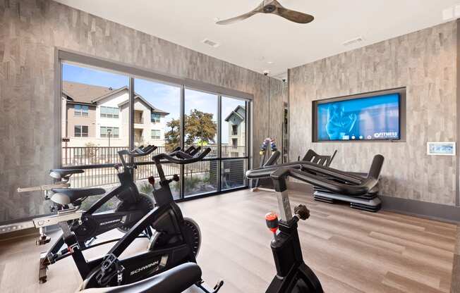 exercise room with amenities at ironridge at hill country village apartments