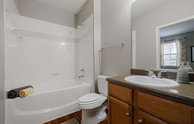 a bathroom with a sink toilet and bath tub