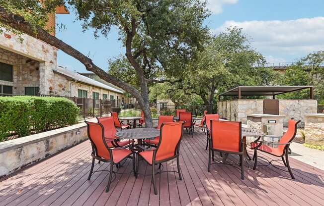 a patio with a table and chairs and a fire pit