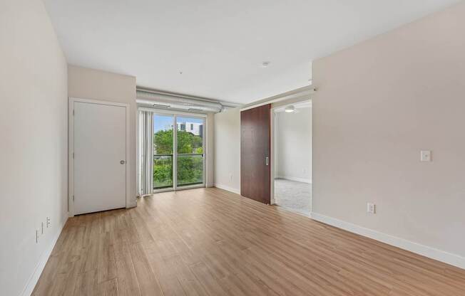 A room with a white wall and a brown door.