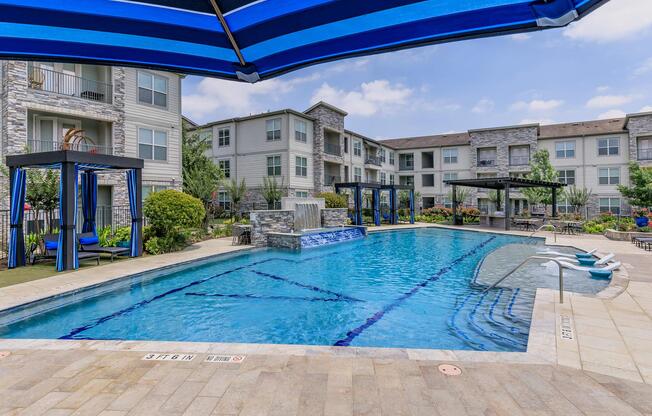 a blue pool of water in front of a building