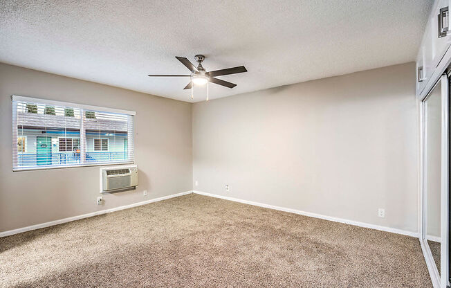 The Island Apartments unfurnished bedroom with ceiling fan