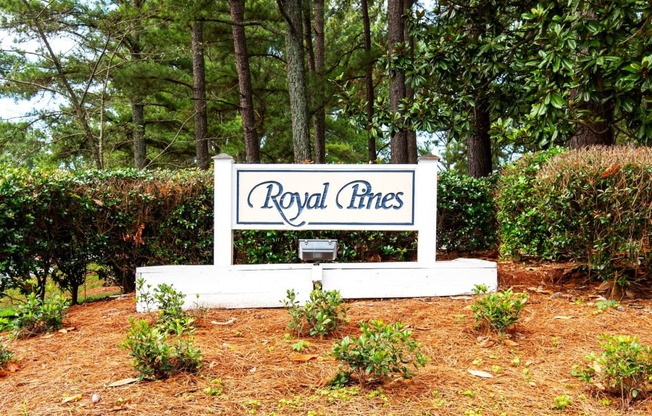 a sign that says royal lines in front of some trees