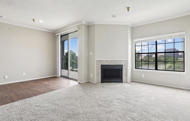 A2 floor plan living room with a fireplace and sliding glass doors that open to balcony at Jefferson Creek Apartments in Irving, TX.